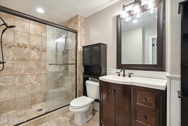 bathroom with vanity, toilet, an enclosed shower, and tile patterned flooring