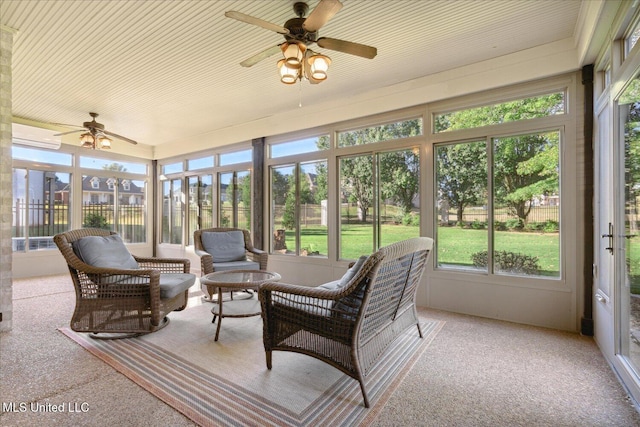 sunroom featuring ceiling fan and a wall mounted air conditioner