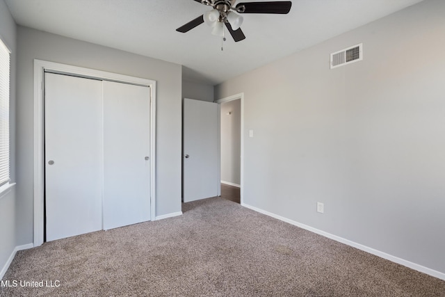 unfurnished bedroom with carpet floors, ceiling fan, and a closet