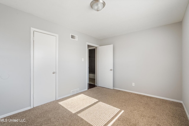 unfurnished bedroom featuring a closet and carpet floors