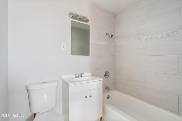 full bathroom featuring toilet, vanity, and tiled shower / bath