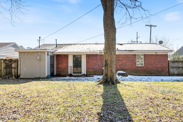 rear view of property featuring a yard