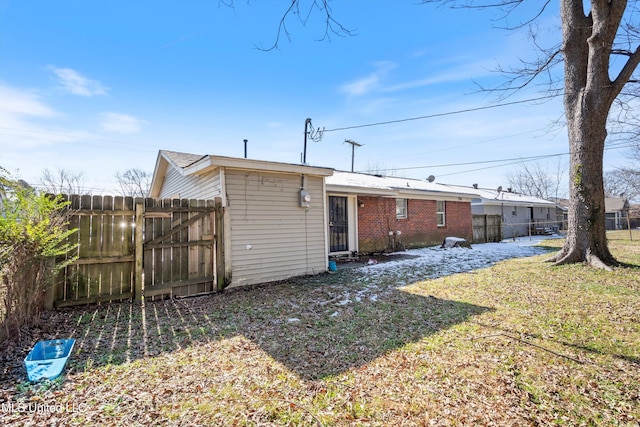 rear view of property with a lawn