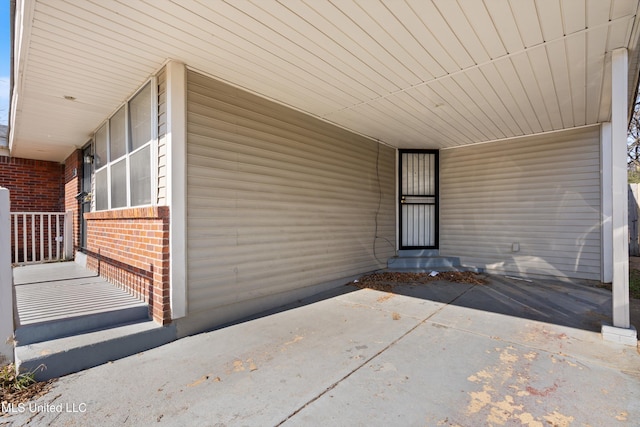 entrance to property featuring a carport