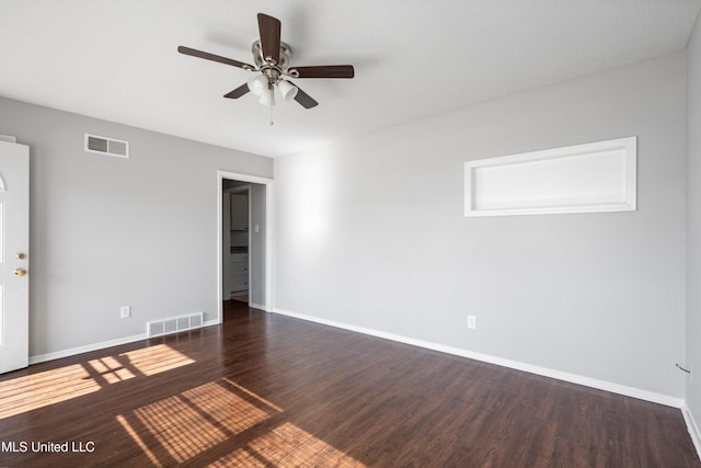 empty room with ceiling fan and dark wood-type flooring