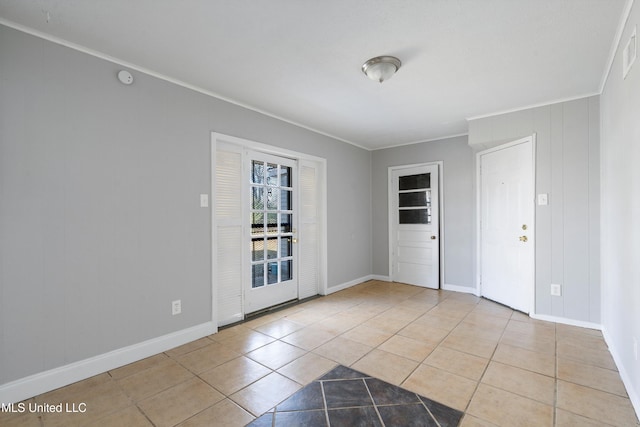 tiled spare room with ornamental molding