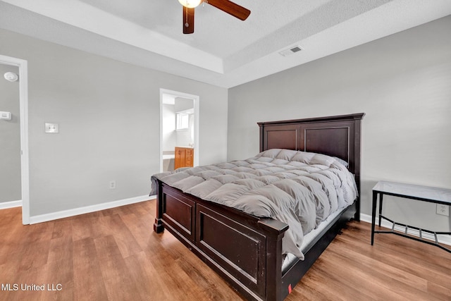 8968 Tahoe Cv, Olive Branch, MS 38654 - bedroom with light wood-type flooring, a tray ceiling, and ceiling fan