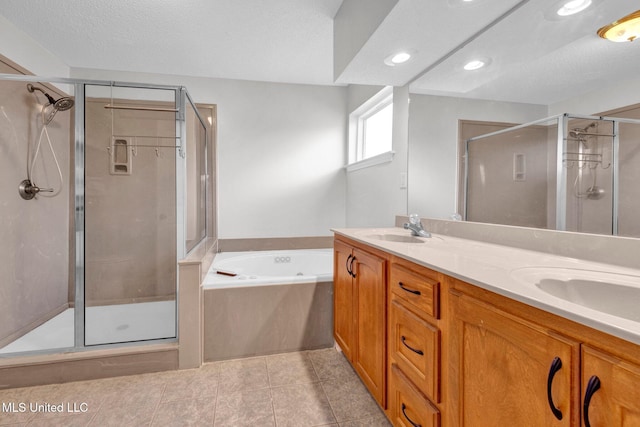8968 Tahoe Cv, Olive Branch, MS 38654 - full bathroom featuring a shower stall, a garden tub, double vanity, recessed lighting, and tile patterned flooring