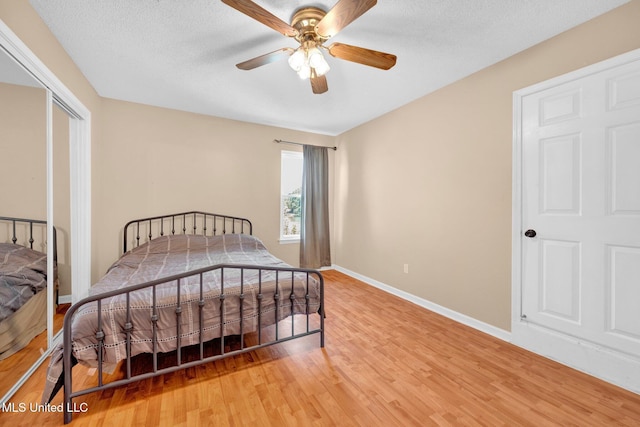 8968 Tahoe Cv, Olive Branch, MS 38654 - bedroom featuring light wood-style flooring, a ceiling fan, and a textured ceiling