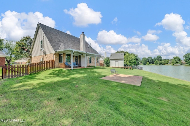 8968 Tahoe Cv, Olive Branch, MS 38654 - rear view of property featuring brick siding, a chimney, a water view, a patio, and roof with shingles
