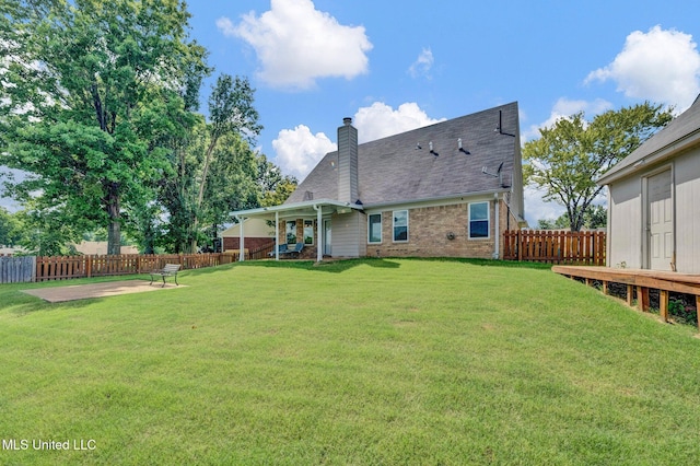 8968 Tahoe Cv, Olive Branch, MS 38654 - back of property featuring brick siding, a fenced backyard, a chimney, a patio, and a shingled roof
