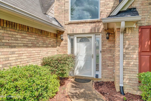 8968 Tahoe Cv, Olive Branch, MS 38654 - doorway to property featuring brick siding and a shingled roof