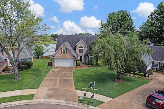 8968 Tahoe Cv, Olive Branch, MS 38654 - traditional-style house with a front yard, a garage, driveway, and stone siding