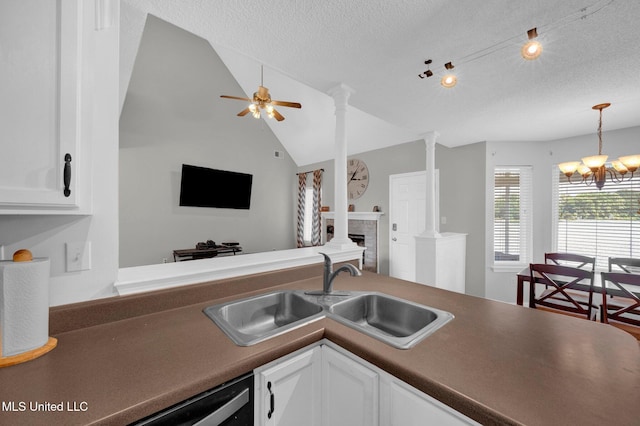 8968 Tahoe Cv, Olive Branch, MS 38654 - kitchen featuring white cabinets, a textured ceiling, vaulted ceiling, a chandelier, and hanging light fixtures