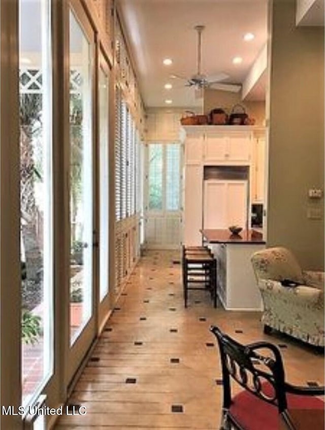 sunroom with ceiling fan and plenty of natural light