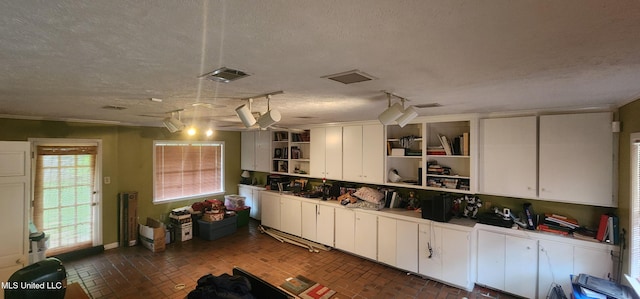 32 Raintree Pl, Jackson, MS 39211 - kitchen featuring white cabinetry, brick floor, open shelves, and visible vents