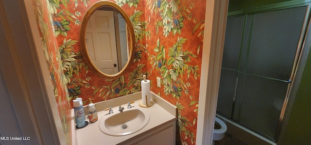 32 Raintree Pl, Jackson, MS 39211 - bathroom featuring wallpapered walls, a shower with shower door, toilet, and vanity