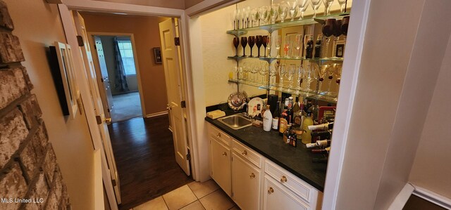 32 Raintree Pl, Jackson, MS 39211 - bar with wet bar, a sink, and light tile patterned floors