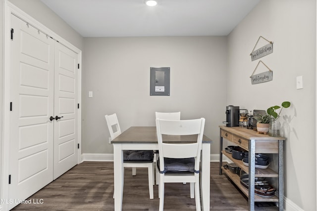 dining space with dark hardwood / wood-style flooring and electric panel