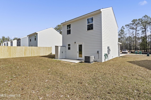 back of house featuring a lawn, a patio area, and central air condition unit