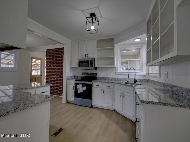 kitchen with open shelves, stainless steel appliances, visible vents, white cabinetry, and a sink