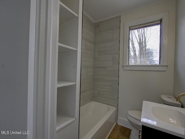 bathroom with toilet, ornamental molding, wood finished floors, and vanity