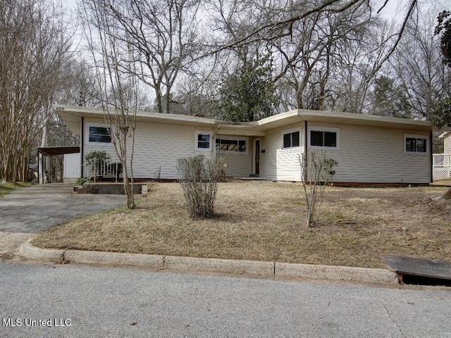 single story home with aphalt driveway and a carport