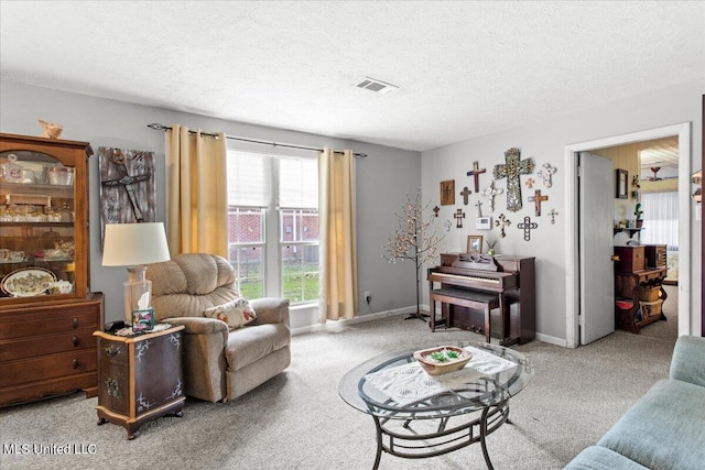 carpeted living room featuring a textured ceiling