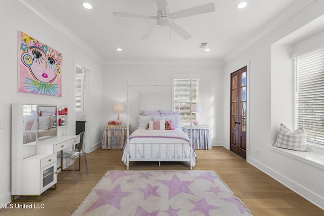 bedroom with ceiling fan, light hardwood / wood-style floors, and ornamental molding