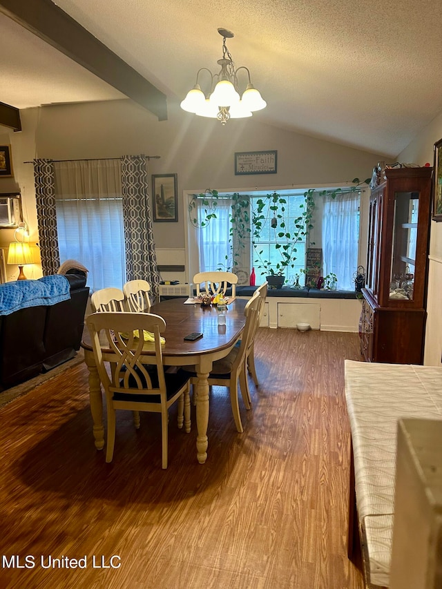 2236 Long St, Grenada, MS 38901 - dining space with a notable chandelier, hardwood / wood-style floors, lofted ceiling with beams, and a textured ceiling