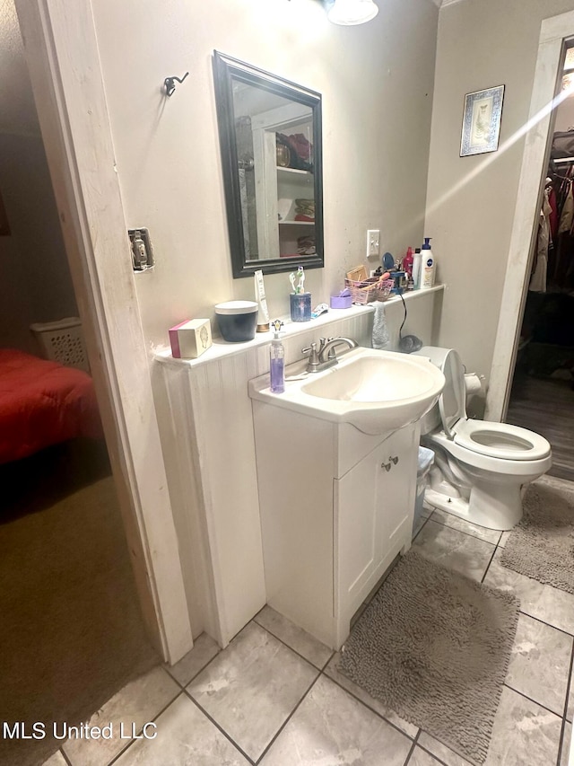 2236 Long St, Grenada, MS 38901 - bathroom featuring vanity, toilet, and tile patterned floors