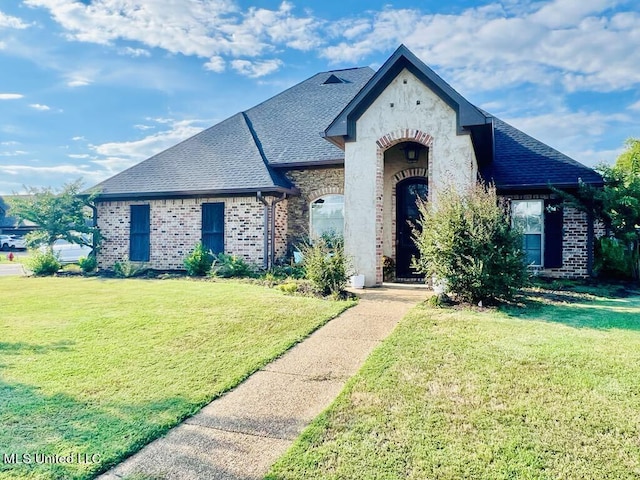 french provincial home featuring a front yard