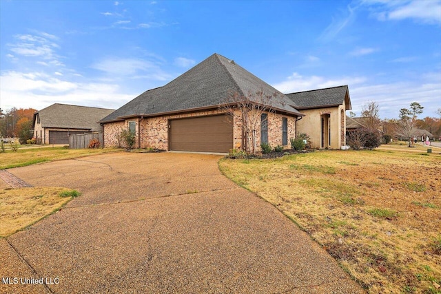 view of front of home with a front yard and a garage