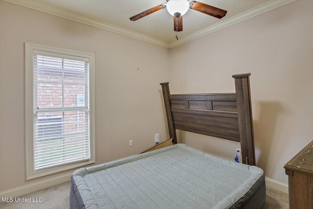 carpeted bedroom with ceiling fan and crown molding