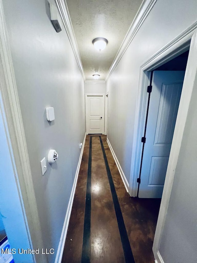 hallway with ornamental molding and dark wood-type flooring