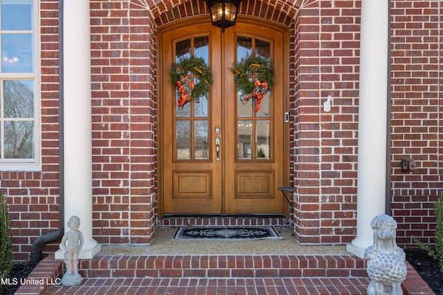 doorway to property with brick siding and french doors