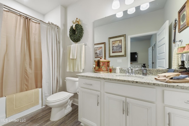 full bath with toilet, wood finished floors, and vanity