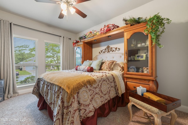carpeted bedroom with multiple windows and ceiling fan
