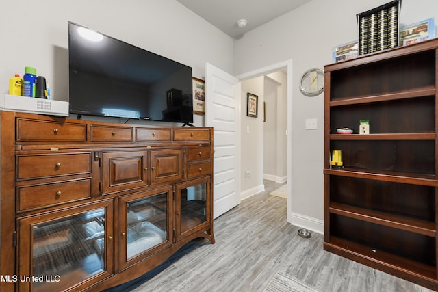 living room with light wood finished floors and baseboards