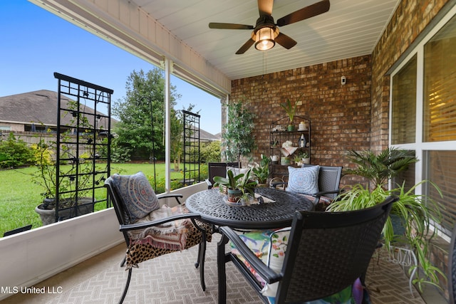 sunroom / solarium featuring a ceiling fan