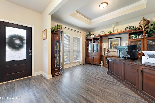 home office featuring wood finished floors, baseboards, ornamental molding, and a tray ceiling