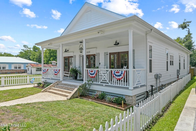 view of front of home with a porch and a front yard