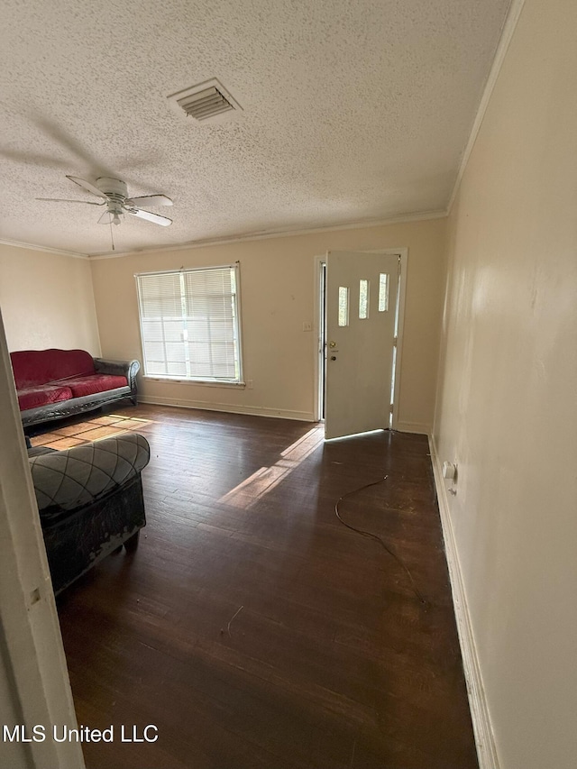 entrance foyer with dark hardwood / wood-style floors, ceiling fan, crown molding, and a textured ceiling