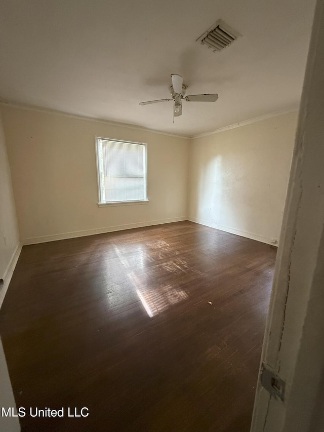 empty room with dark hardwood / wood-style floors, ceiling fan, and ornamental molding