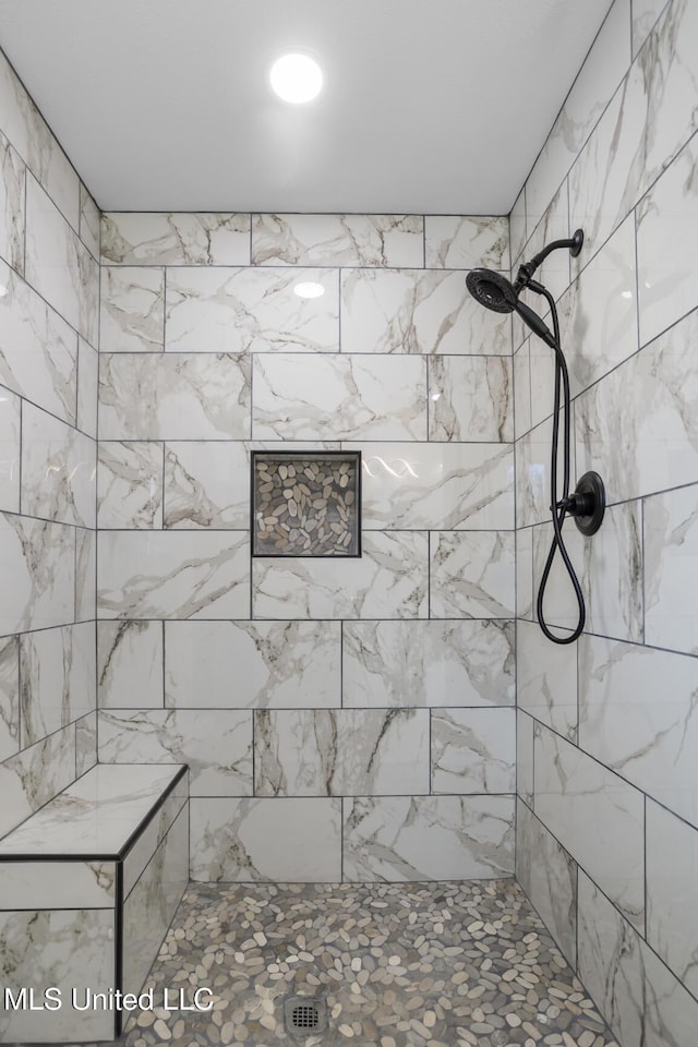 bathroom with tiled shower