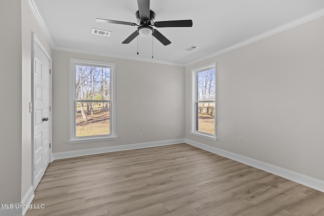 unfurnished bedroom featuring visible vents, crown molding, and multiple windows