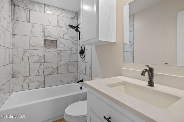 bathroom with bathtub / shower combination, vanity, and toilet