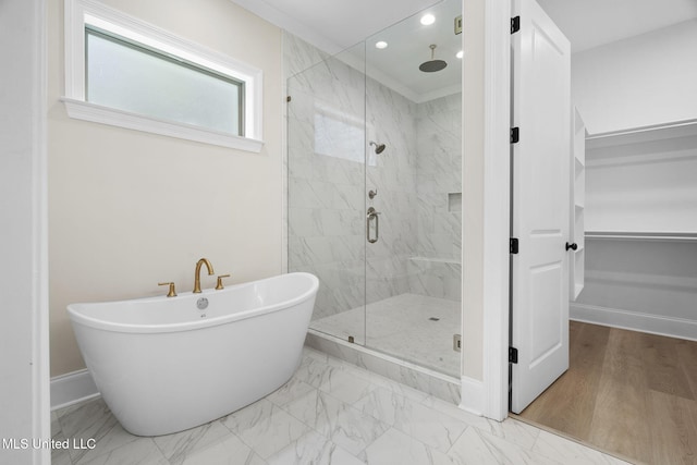 563 Valentine Rd, Holly Springs, MS 38635 - full bathroom featuring a marble finish shower, a freestanding bath, a walk in closet, marble look tiles, and recessed lighting