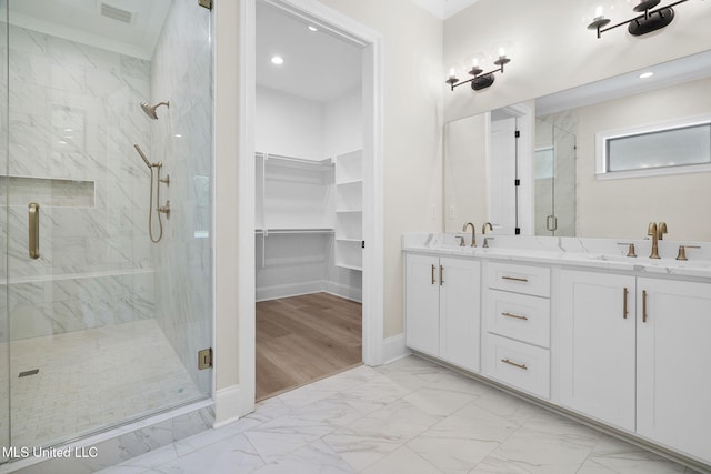 563 Valentine Rd, Holly Springs, MS 38635 - bathroom with a marble finish shower, marble finish flooring, double vanity, a spacious closet, and recessed lighting