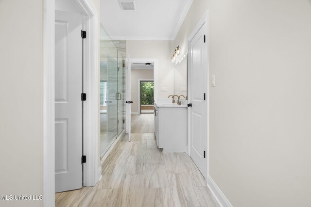 563 Valentine Rd, Holly Springs, MS 38635 - corridor with ornamental molding and light marble finish flooring